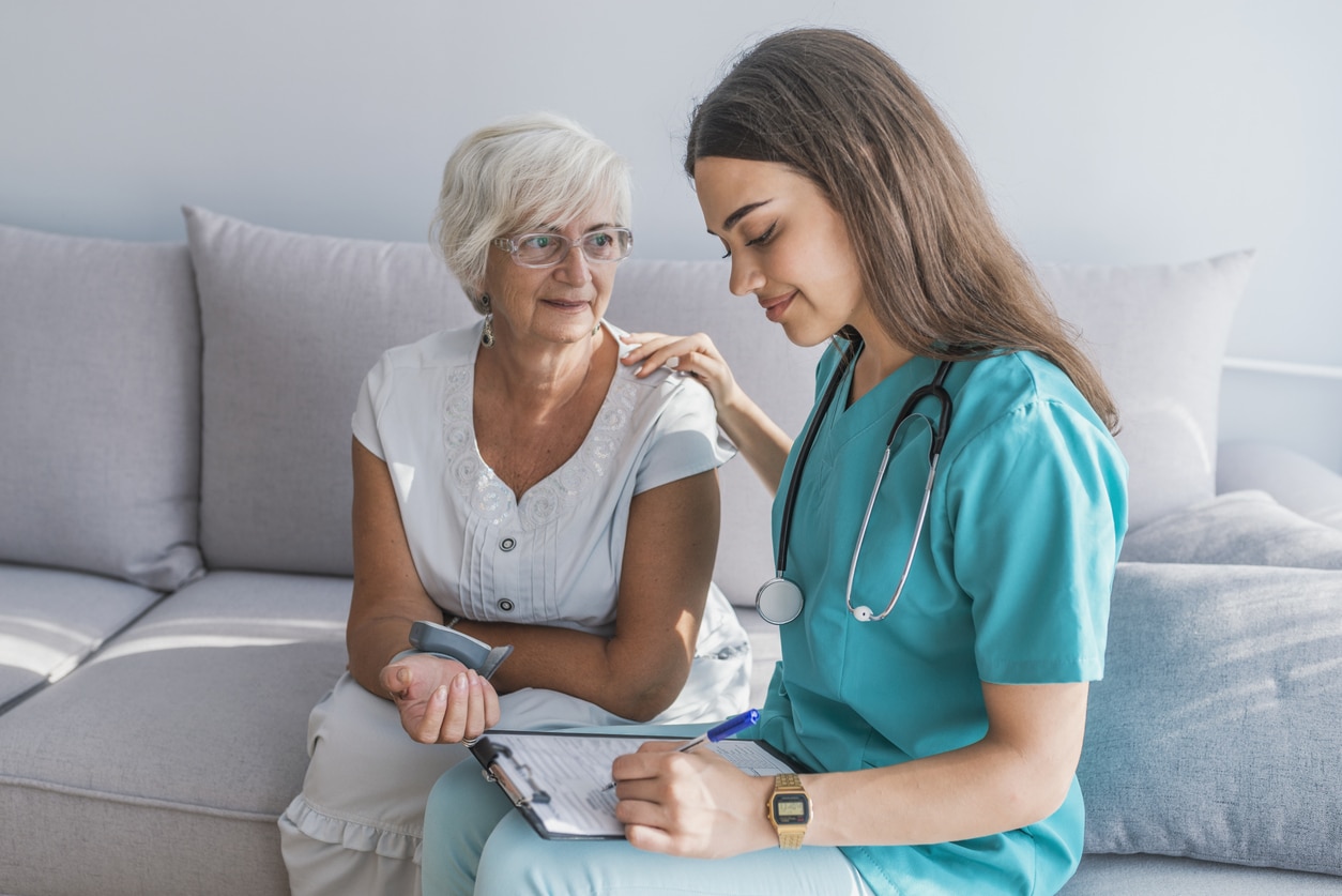 Mariam Nour sitting on a couch using a laptop