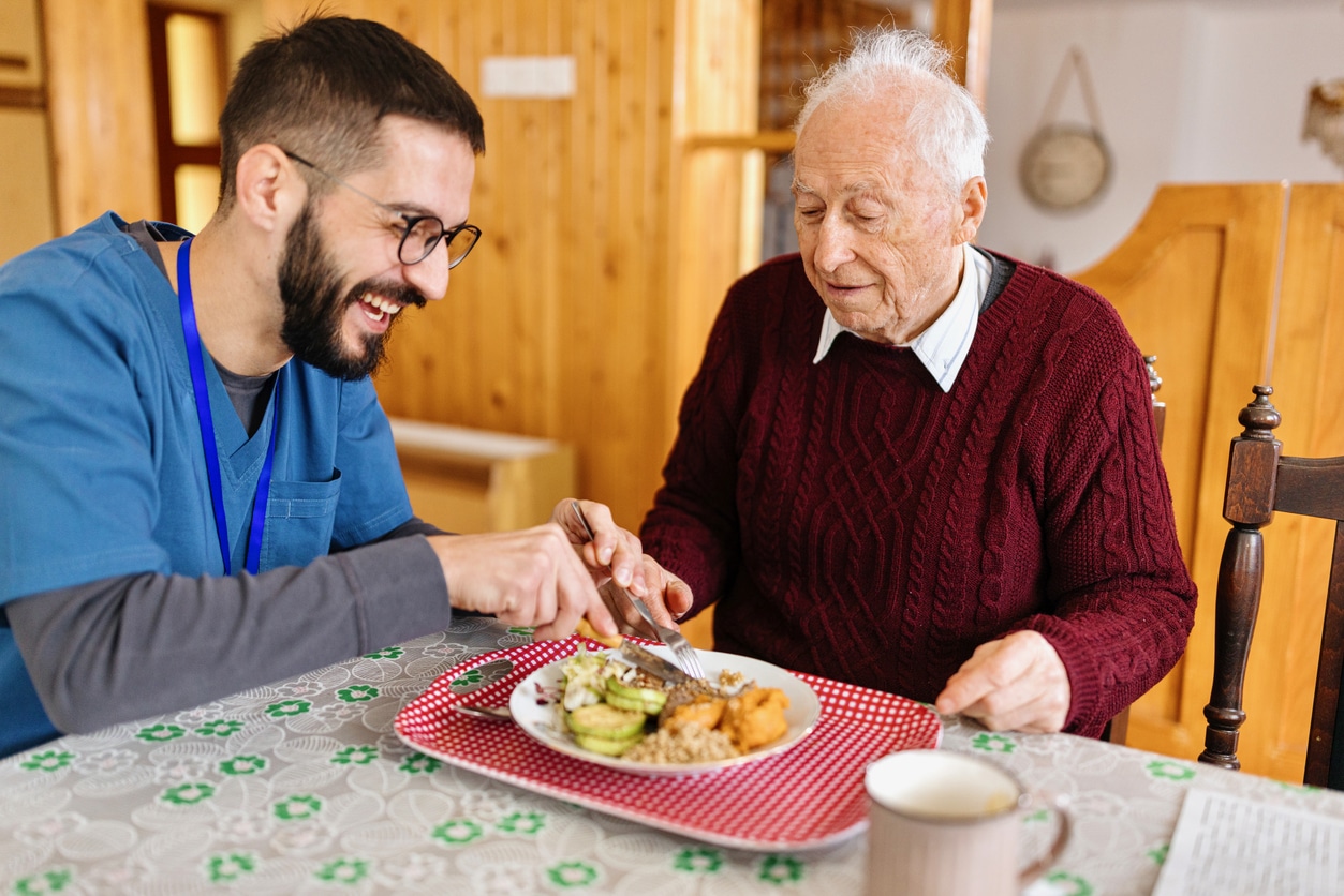 a person sitting at a table with a plate of food