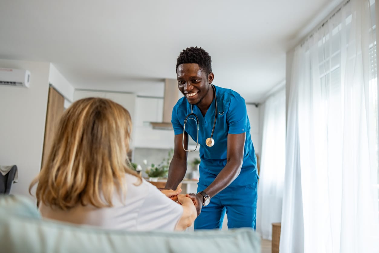 a man and a woman standing in a room a nurse and a resident standing in a room